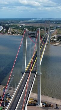 Vertical drone shot following a car driving on a bridge, in Maputo ,Mozambique