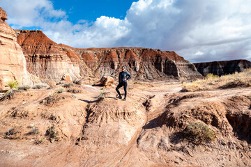 Beautiful female hiker at Toadstool Hoodoos at toadstool trail at Grand Staircase-Escalante...