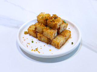 asian deep fried crispy vegetable carrot cake in square w garlic onion spices in plate on marble table chinese dim sum menu banquet restaurant vegan halal food