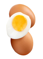 Front view of raw brown chicken eggs and cooked or boiled chicken egg with egg yolk in half in small pile isolated with clipping path in png file format