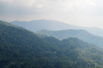 Obraz premium Dust pm 2.5 and Mist Clouds, High Angle Landscape view over Forest Mountains at Doi Langka Noi, Khun Chae National Park Northern Thailand.