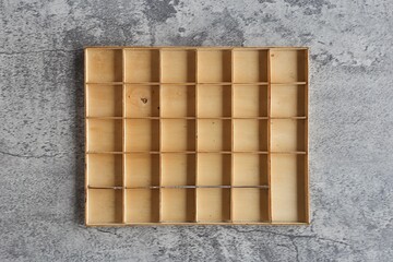 Empty wooden square box on modern cement background