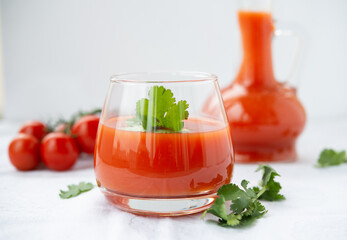 Tomato juice in a glass on a white background