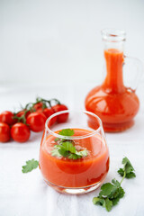 Tomato juice in a glass on a white background