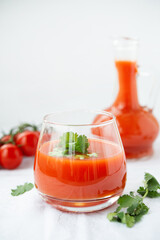 Tomato juice in a glass on a white background