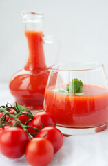 Tomato juice in a glass on a white background