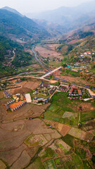 Aerial view of Sapan Village in Mueang Nan District, a hidden gem in Thailand rice field and river in mountains landscape