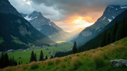 Obraz premium Misty Engadin Valley in Switzerland at dawn, covered in rain-soaked greenery. The moody atmosphere is enhanced by low clouds and soft morning light. A high-quality landscape photo.