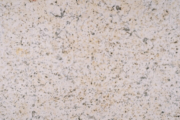 Background of natural stone with brown dots, chips and cracks