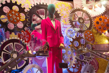 Female mannequin in an elegant suit in a showcase of original design