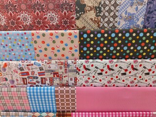 Fototapeta premium displaying a pile of wrapping paper with various attractive motifs and colors 