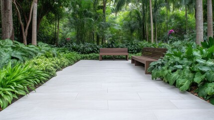 Obraz premium Tranquil garden path with benches. Lush greenery surrounds a paved walkway