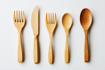 Collection of wooden utensils including forks, knife, and spoons arranged neatly on a white background for kitchen use