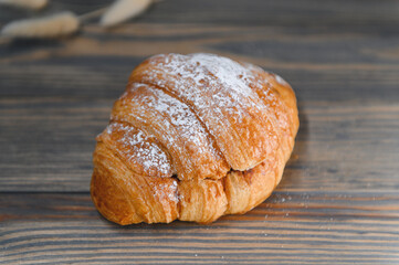 fresh baked croissant isolated on a wooden background