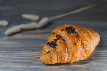 fresh baked croissant isolated on a wooden background