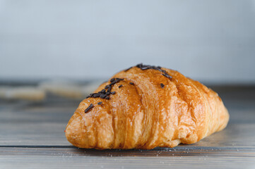 fresh baked croissant isolated on a wooden background
