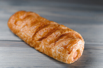Sausage in dough . on a wooden background