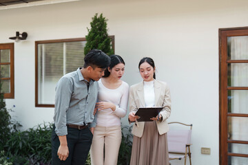 Fototapeta premium Real estate consultation. A group of clients receiving valuable insights from a real estate agent about a property.