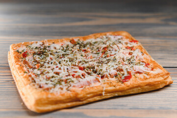 Tasty mini pizza on a wooden background