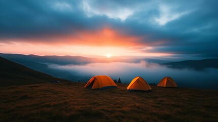 Tranquil sunrise over mountains with orange tents, ideal for adventure, camping, nature retreat concepts