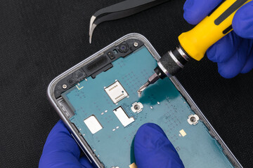 The wizard uses a tool to extract the phone's control panel, close-up