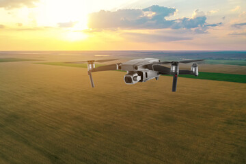 Drone with camera flying over fields. Unmanned aerial vehicle for surveillance