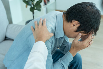 psychiatrist holds shoulders while discussing life and family issues. doctor encourages and empathy...