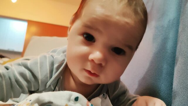 little baby playing with camera