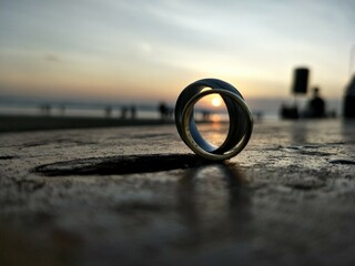 photo of couple's rings on the beach 