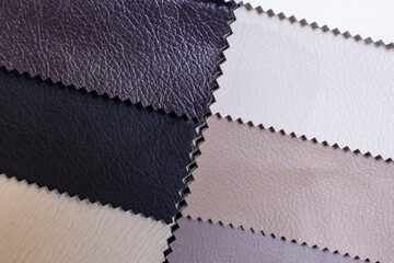 Colorful samples of upholstery fabrics close-up. Leather swatches for furniture renovation