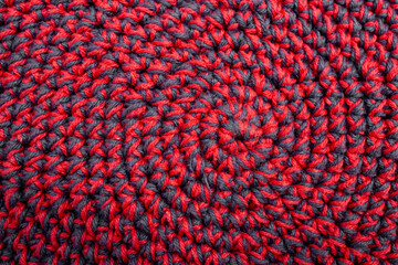 Knitted with a crochet hook, spiral shaped pattern texture, abstract woven backdrop