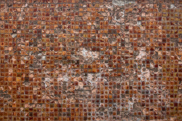 Obsolete textured background of brown  broken little wall tiles