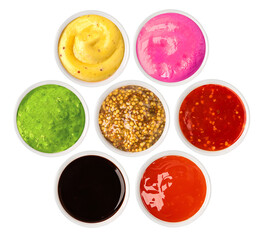 Set of various sauces in bowls, isolated on white background, top view