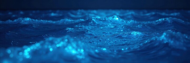 Glowing blue bioluminescence on ocean surface, waves, water