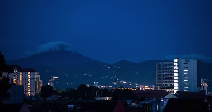 Timelapse of clouds rolling over the mountain top in the evening in Bandung, Indonesia