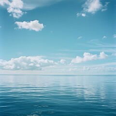 Obraz premium Photo of Calm Ocean Water under a Blue Sky