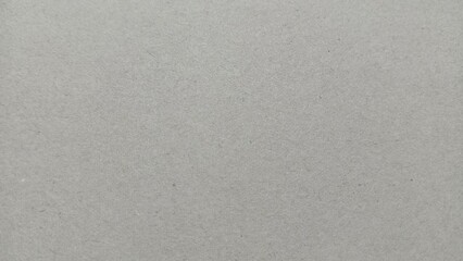 close-up view of a gray recycled paper texture with a rough and fibrous surface. Ideal for backgrounds, design elements, and creative projects