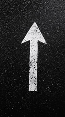 white arrow pointing straight up marked on black asphalt suggesting direction or forward movement

