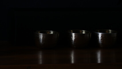 Dark background with three bowls