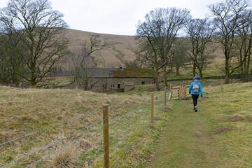 Woman walking in the Edale countryside, to Rush Up Edge.