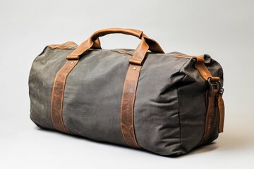 A large gray duffel bag with brown leather handles