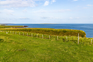 Duncansby Stacks, a breathtaking coastal wonder in Scotland, rise from the North Sea. Standing atop...