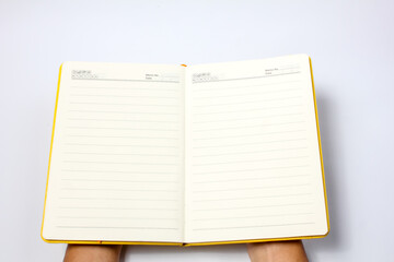 male hand opening notebook on white background.education concept