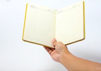 man's hand lifting open notebook on white background