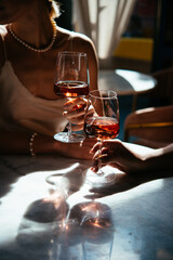 Glasses of rose wine seen during a friendly party or a celebration in a restaurant of a bar.