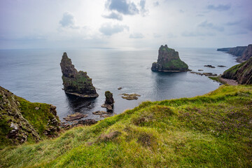 Duncansby Stacks, a breathtaking coastal wonder in Scotland, rise dramatically from the North Sea....