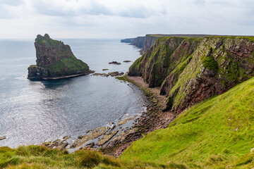 Duncansby Stacks, a breathtaking coastal wonder in Scotland, rise from the North Sea. Standing atop the towering cliffs, visitors are rewarded with rugged landscape, an unforgettable scenic hike.