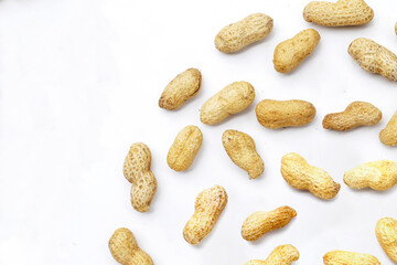 Roasted peanuts in shell on white background.