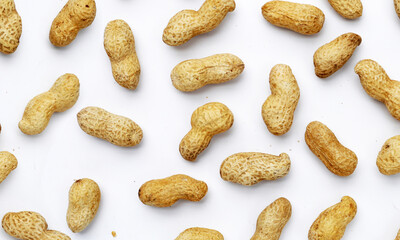 Roasted peanuts in shell on white background.