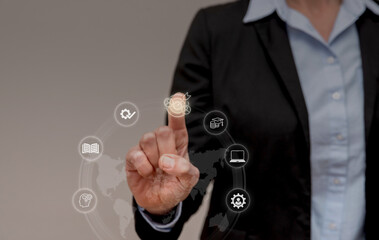 Businesswoman selecting online education icon on futuristic touchscreen interface, e-learning and...